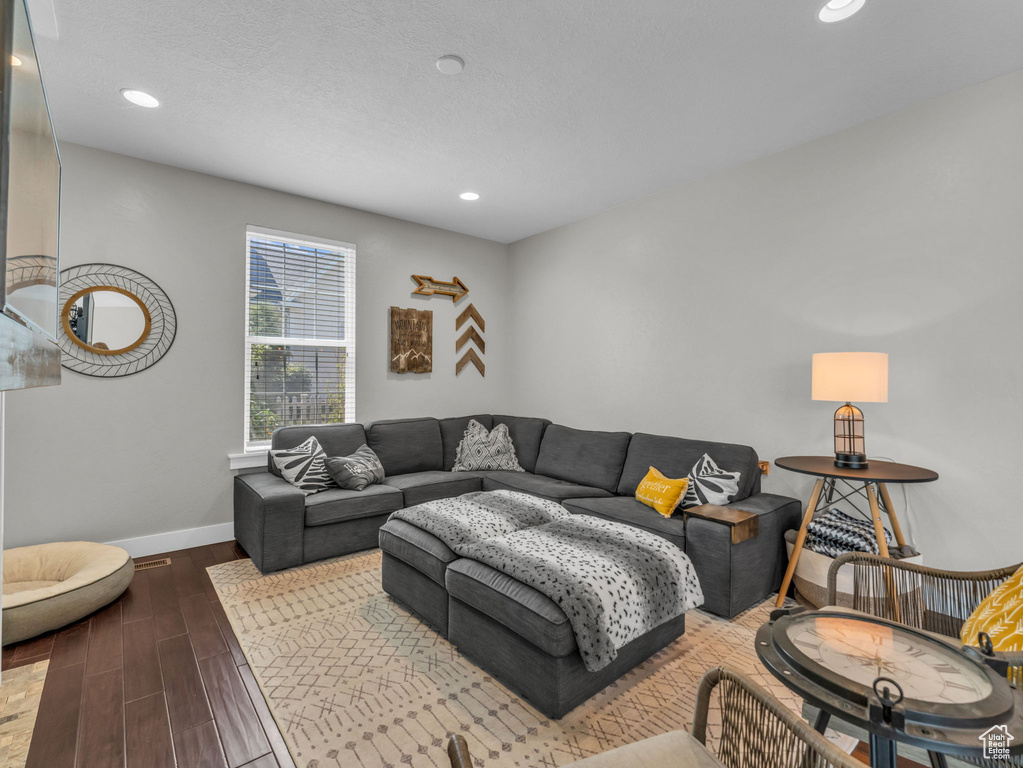 Living area with wood finished floors and recessed lighting