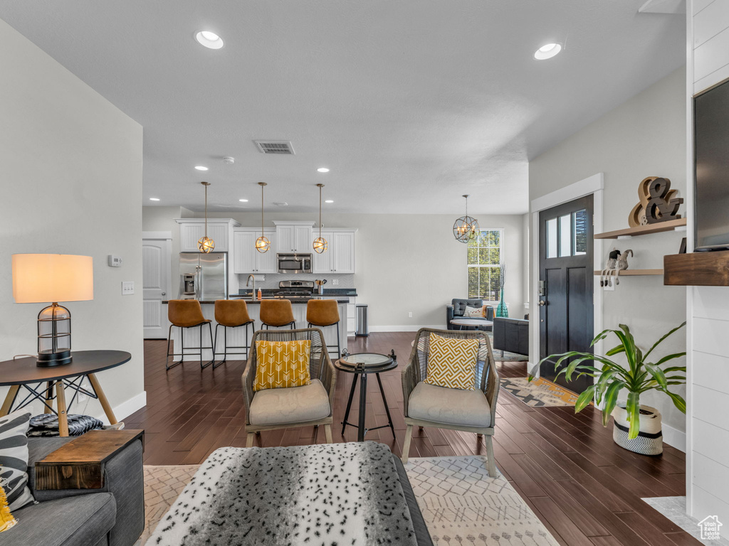 Living room featuring dark wood-type flooring and recessed lighting