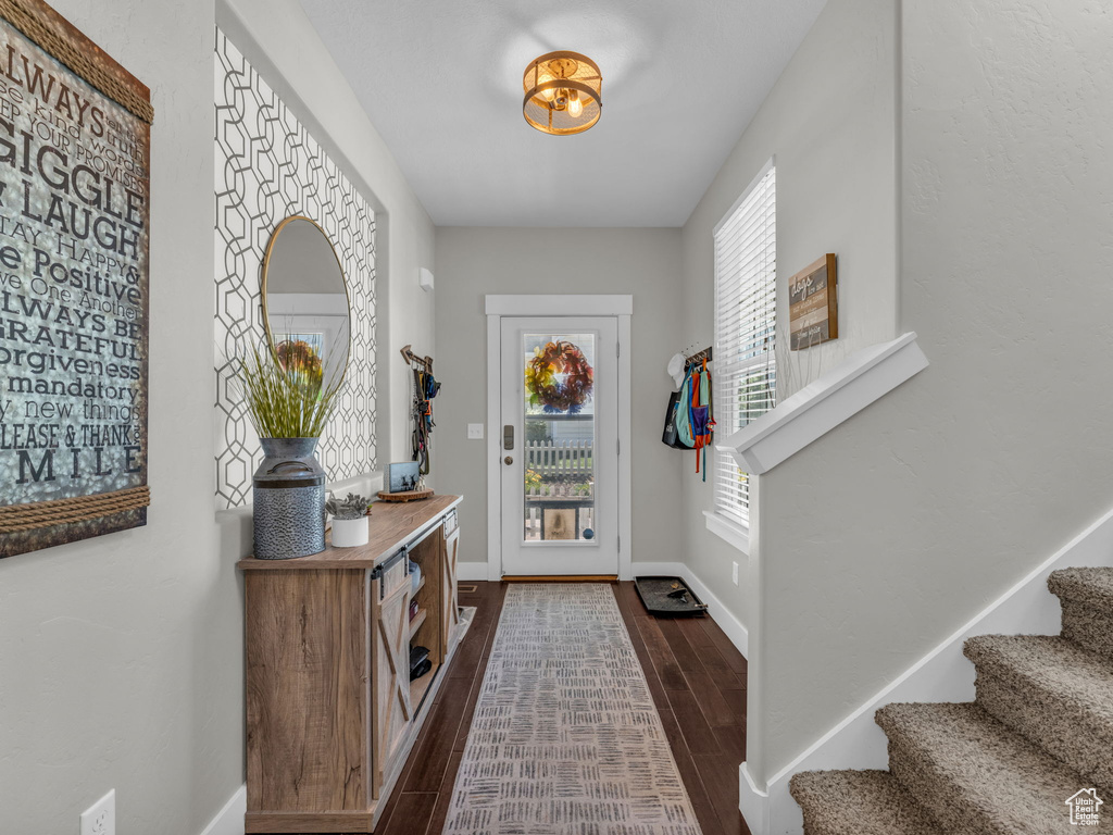 Foyer entrance featuring dark wood finished floors and stairway