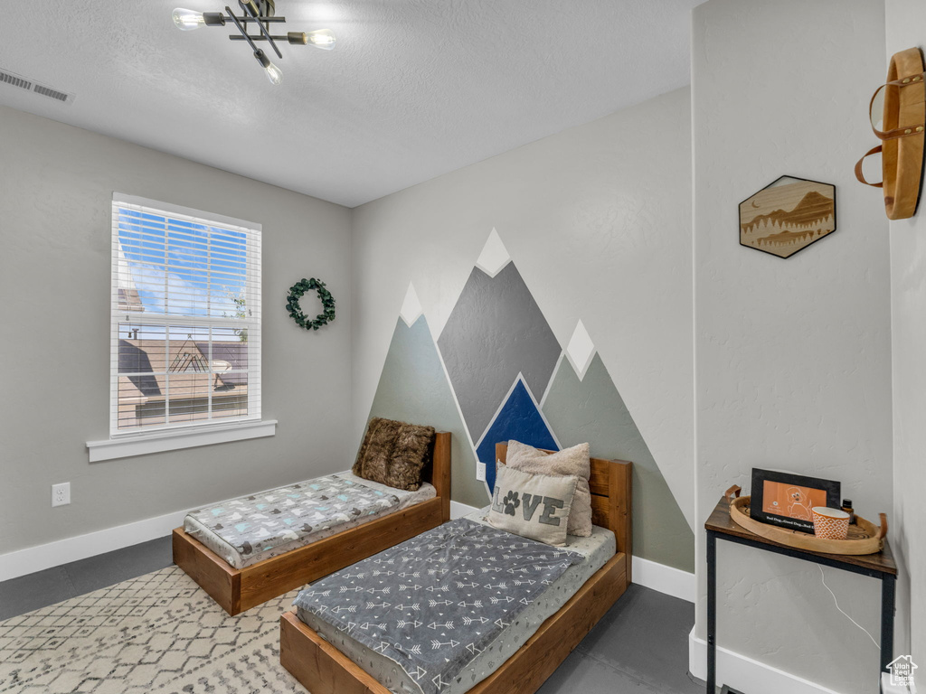 Bedroom with baseboards and a textured ceiling