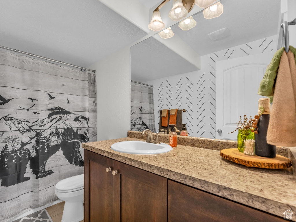 Full bath featuring vanity and curtained shower
