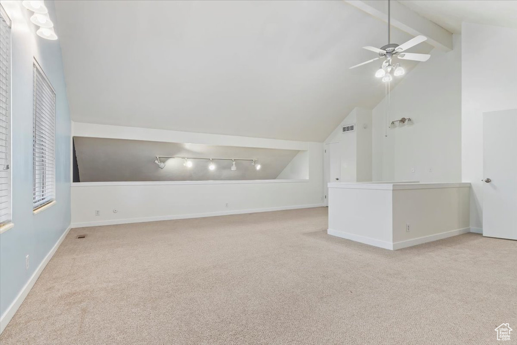 Additional living space with carpet floors and ceiling fan