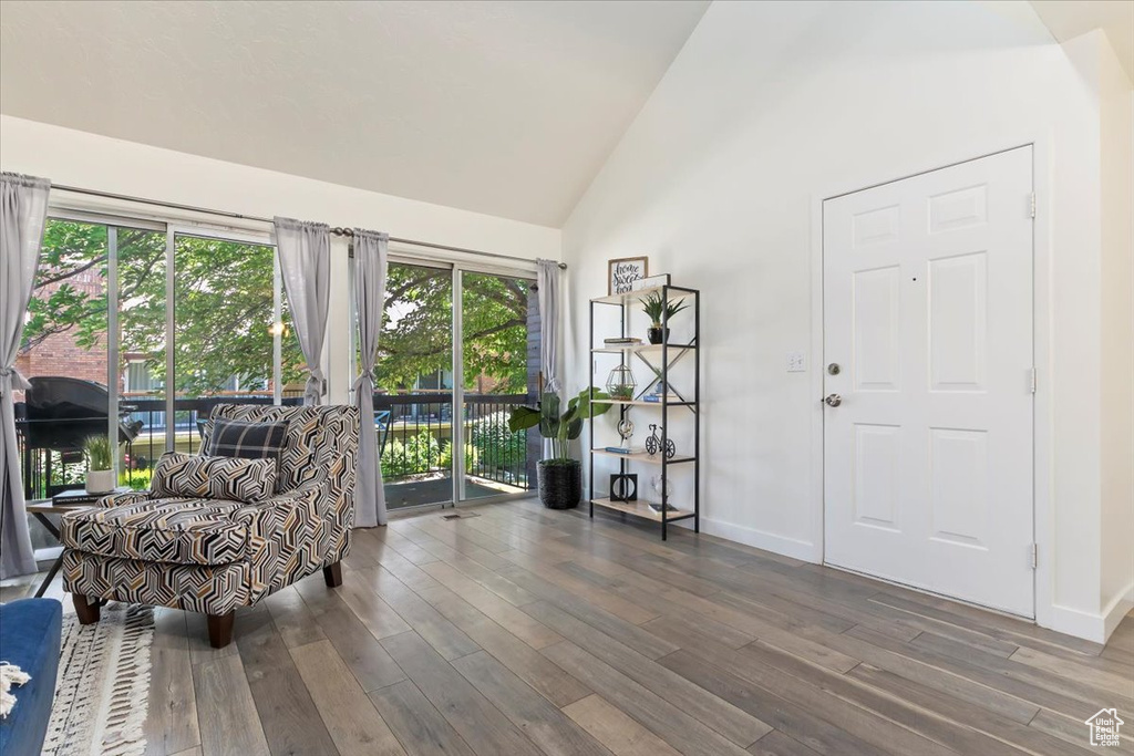 Living area featuring wood finished floors and high vaulted ceiling