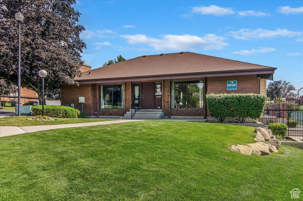 View of front of property with brick siding and a shingled roof