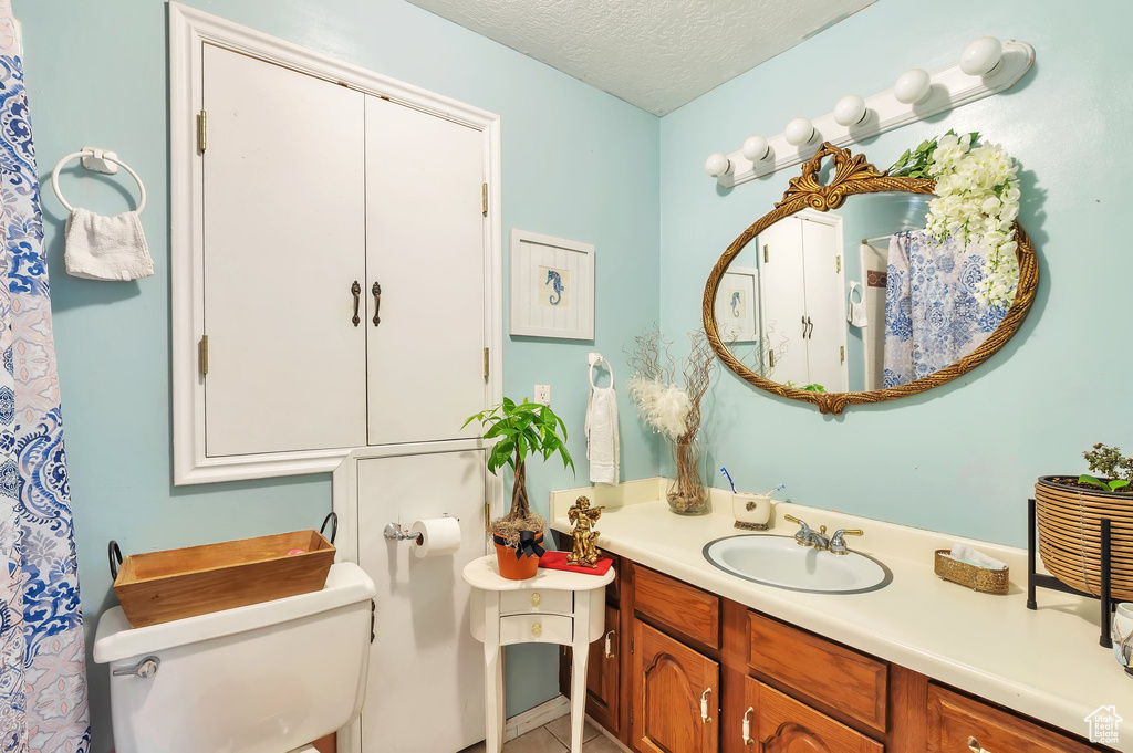 Bathroom with vanity and a textured ceiling