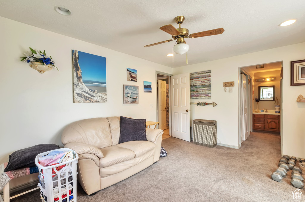 Carpeted living area featuring recessed lighting and a ceiling fan