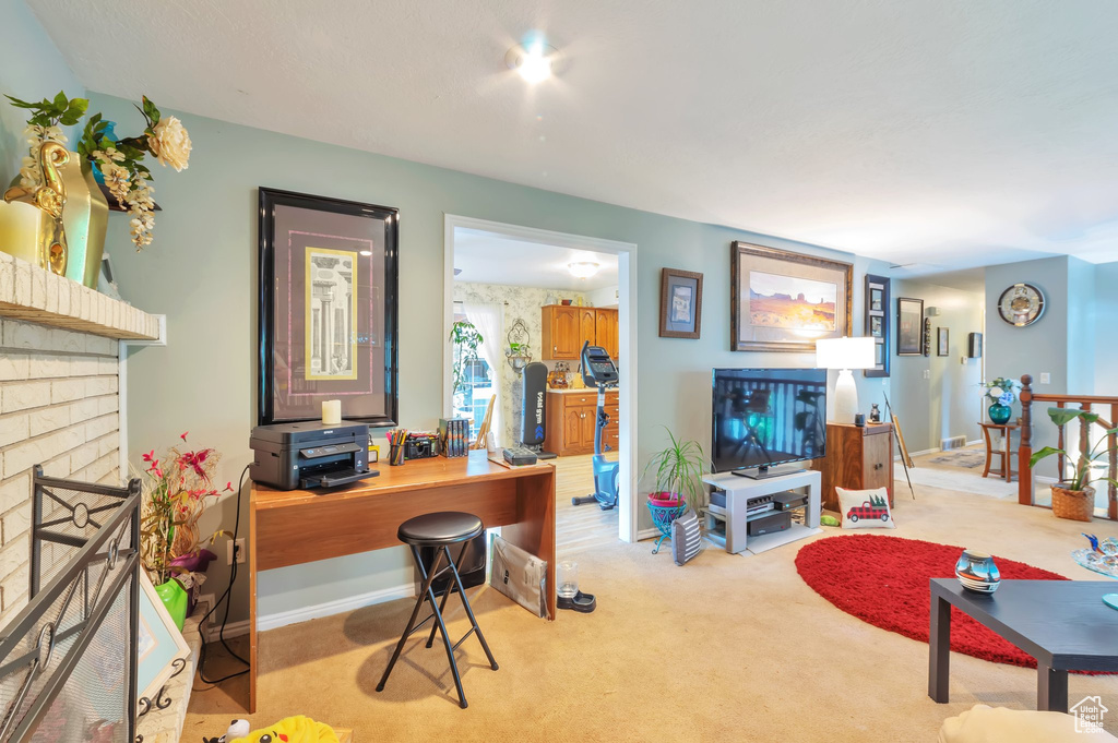 Living room with a brick fireplace and carpet