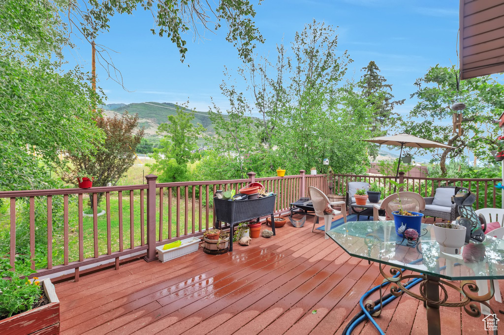 Wooden terrace with a mountain view and outdoor dining space