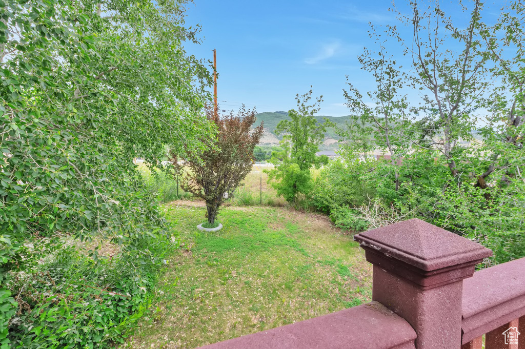 View of green lawn featuring a mountain view