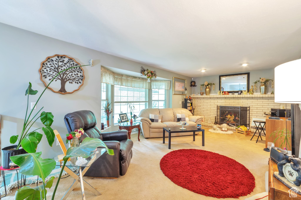 Living room with a brick fireplace and carpet