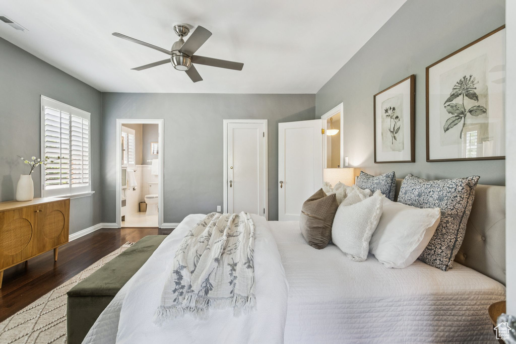 Bedroom with wood finished floors, ensuite bathroom, and a ceiling fan