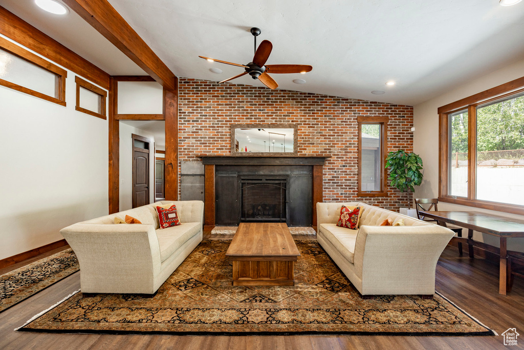 Living area with a fireplace, brick wall, a ceiling fan, wood finished floors, and recessed lighting