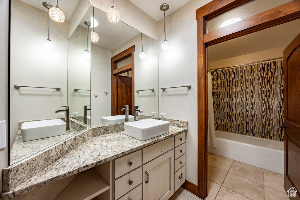 Bathroom with vanity, shower / bath combo, and tile patterned flooring