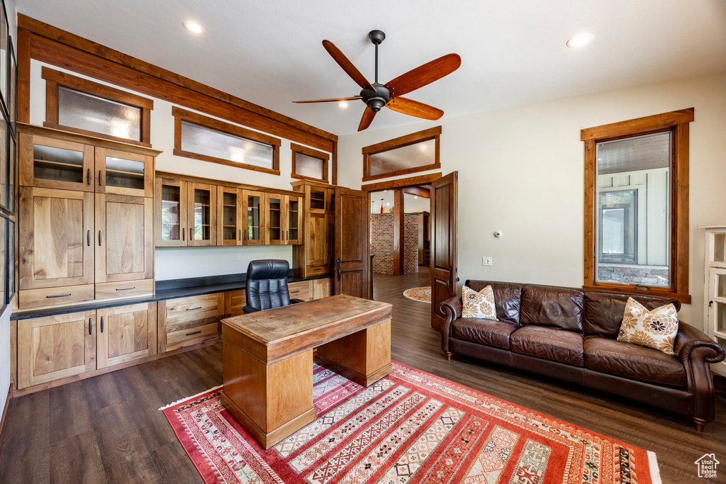 Home office with built in study area, a ceiling fan, dark wood finished floors, and recessed lighting
