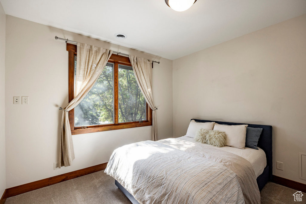 Bedroom featuring carpet floors and baseboards