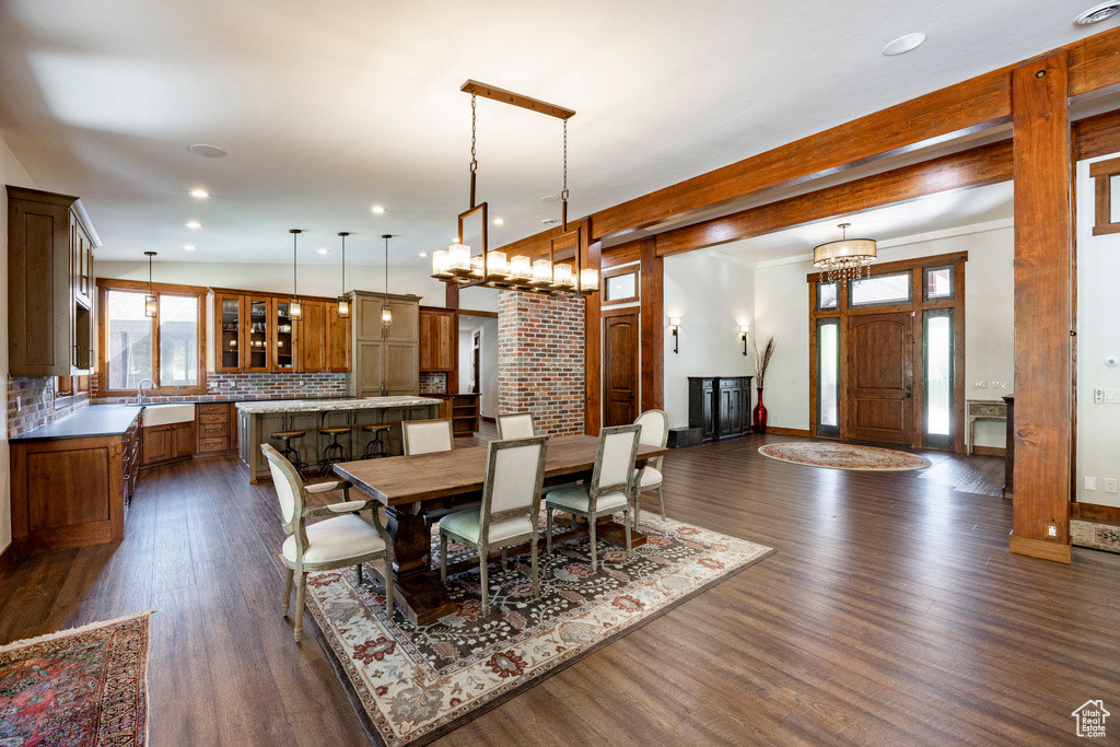 Dining space featuring dark wood-style flooring and recessed lighting