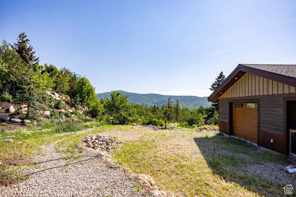 View of yard featuring a mountain view and a garage