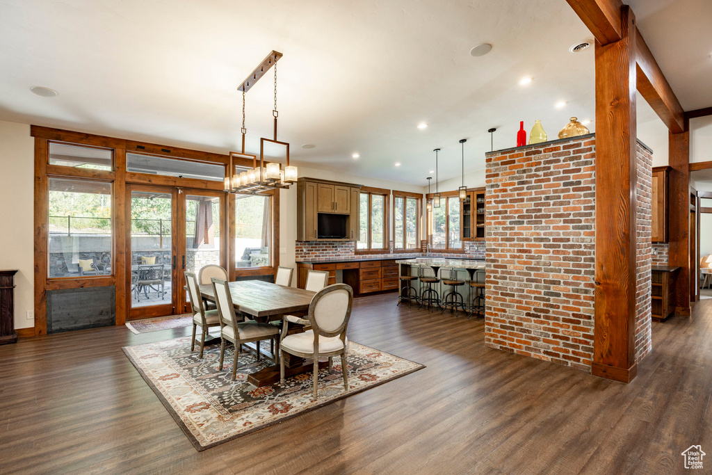 Dining room with dark wood finished floors and recessed lighting