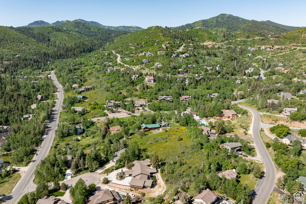 Aerial view of property's location featuring a mountainous background