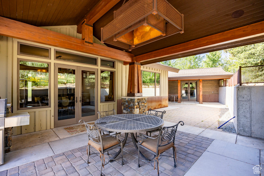 View of patio with french doors and outdoor dining space
