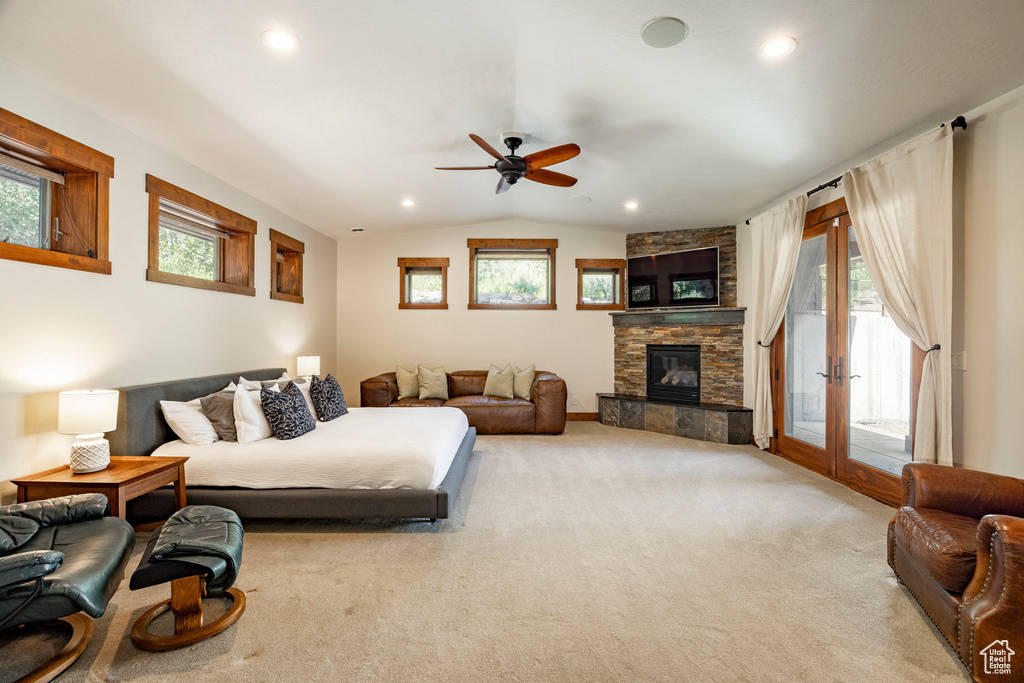 Living room with plenty of natural light, ceiling fan, light colored carpet, vaulted ceiling, and recessed lighting