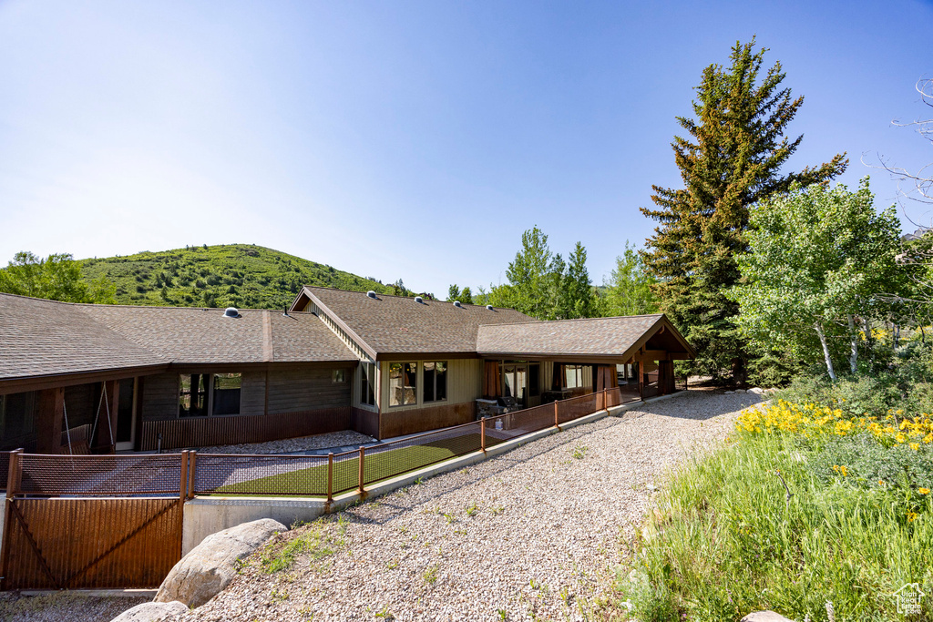 View of front of home featuring a shingled roof and a mountain view