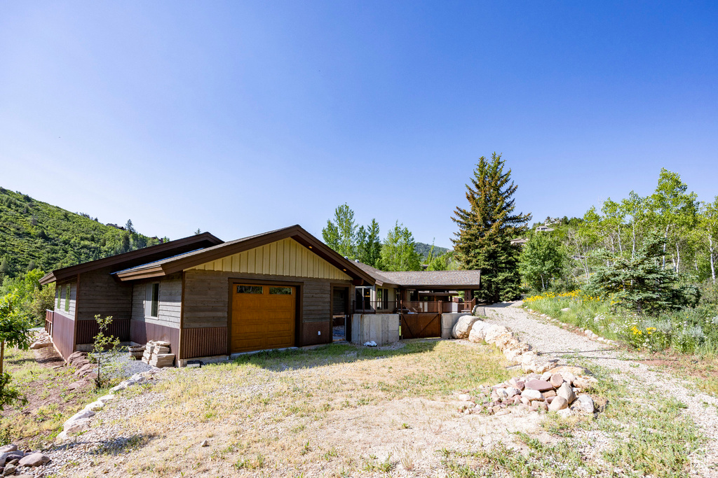 View of front of house featuring a mountain view and an attached garage