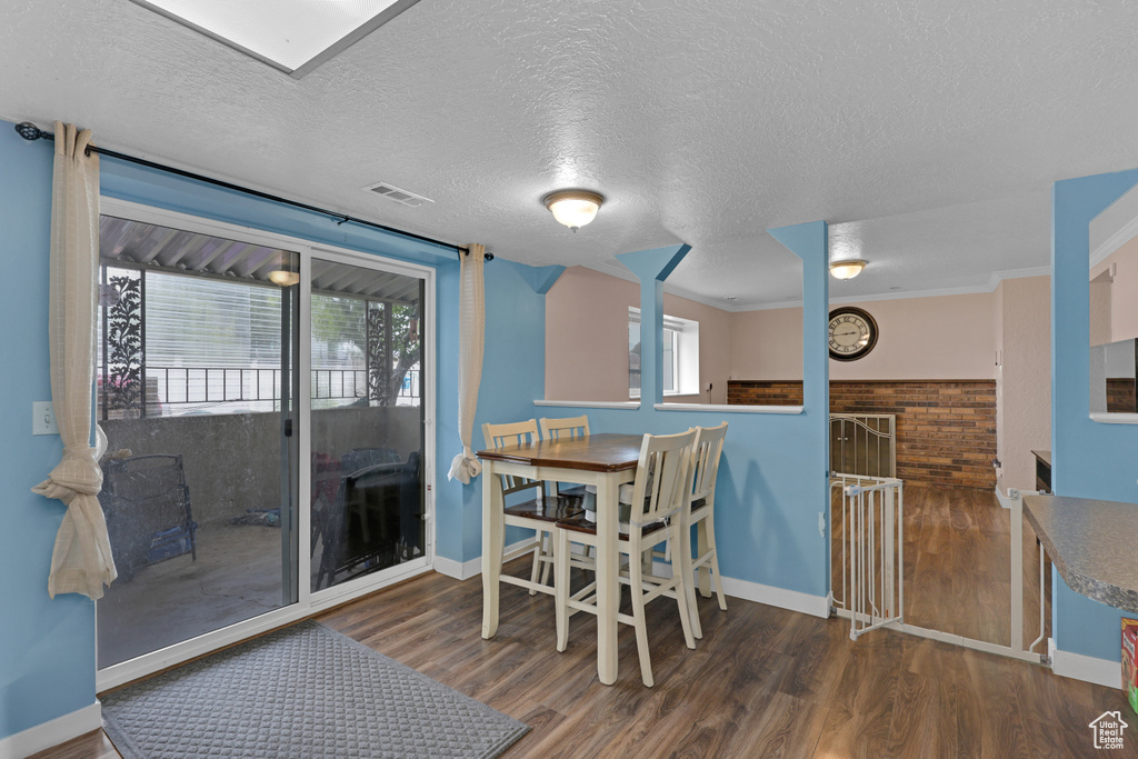 Dining room with wood finished floors and a textured ceiling