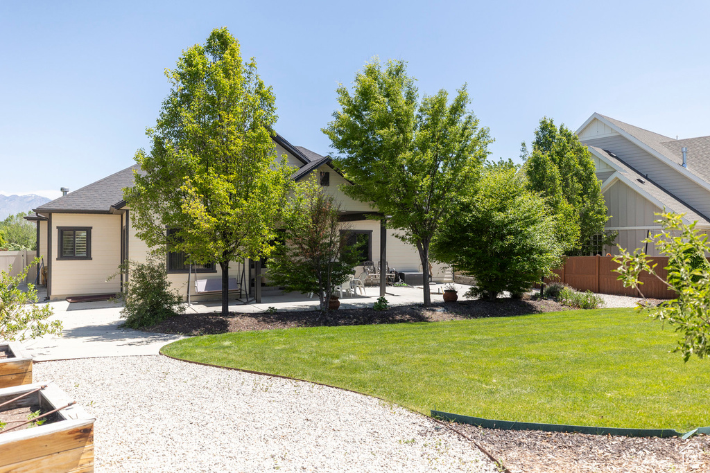 Back of house with a patio