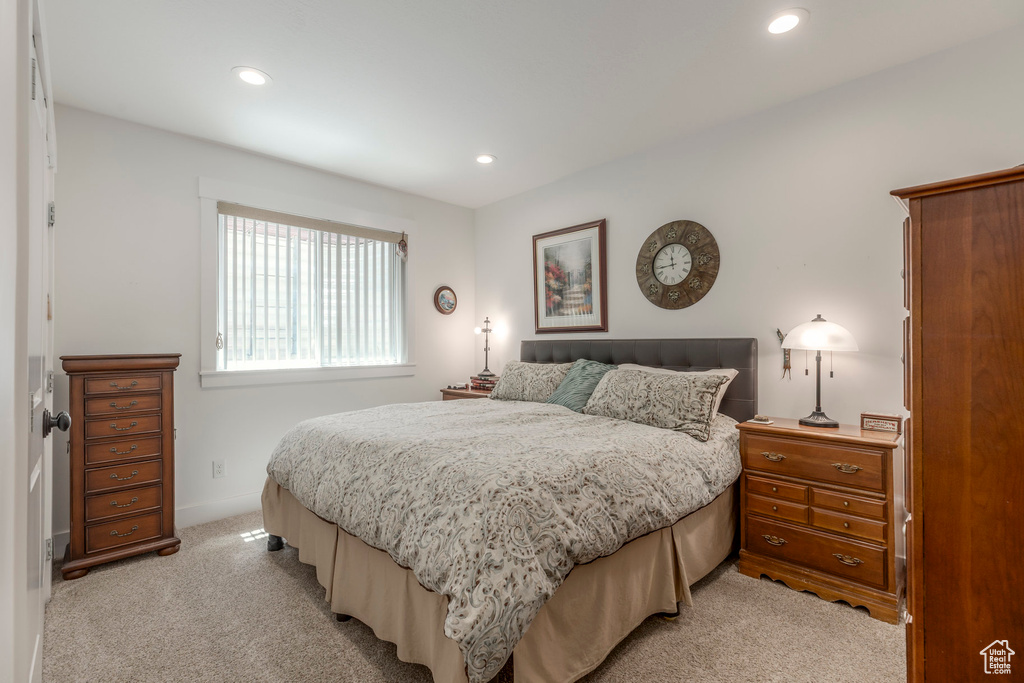 Bedroom with light carpet and recessed lighting