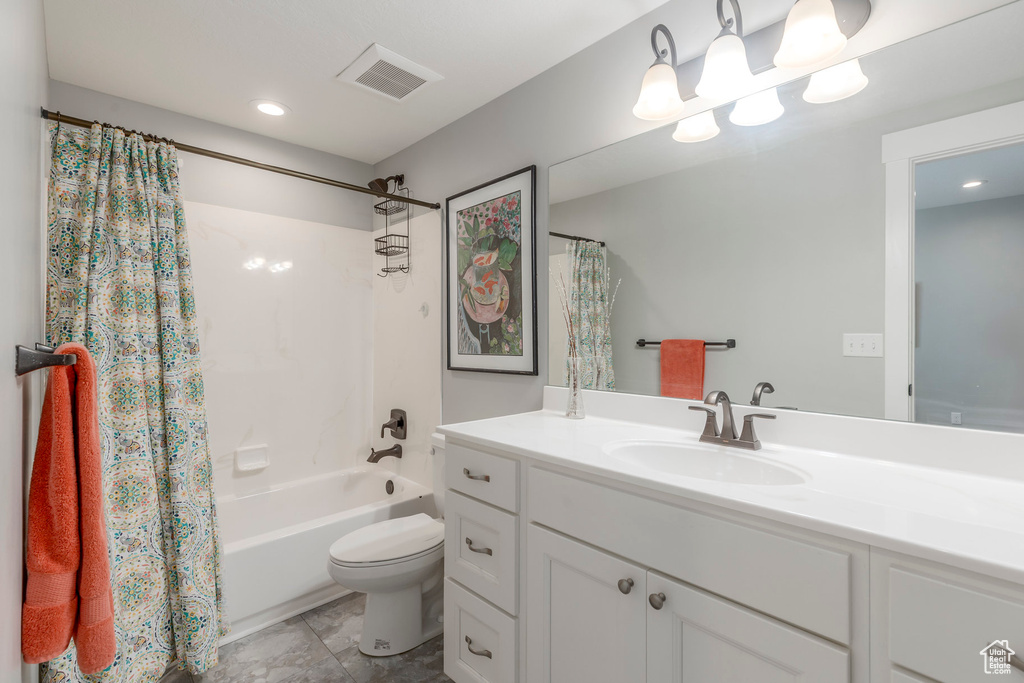 Full bathroom featuring vanity, shower / bathtub combination with curtain, and recessed lighting