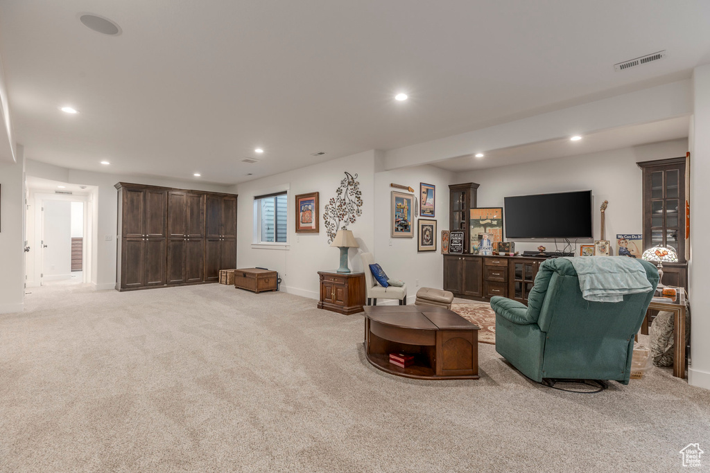 Living area featuring recessed lighting and light colored carpet