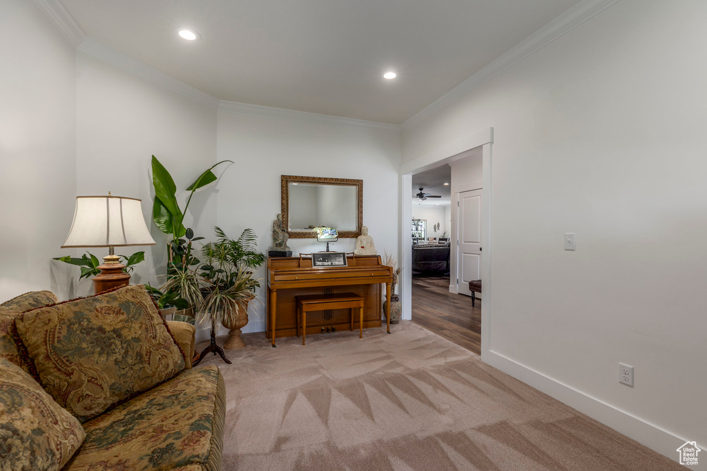 Living area featuring crown molding, recessed lighting, and carpet floors