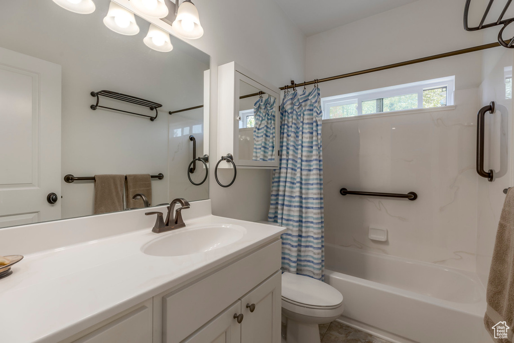 Bathroom featuring shower / tub combo and vanity