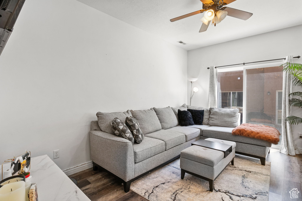 Living room featuring wood finished floors and a ceiling fan