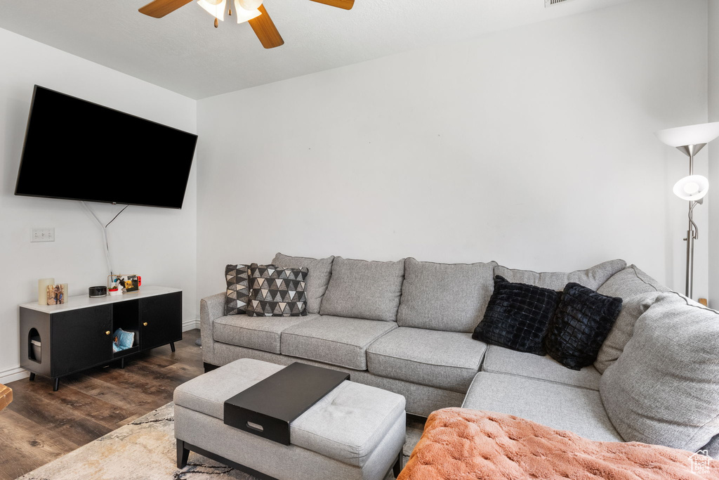 Living room featuring ceiling fan and wood finished floors