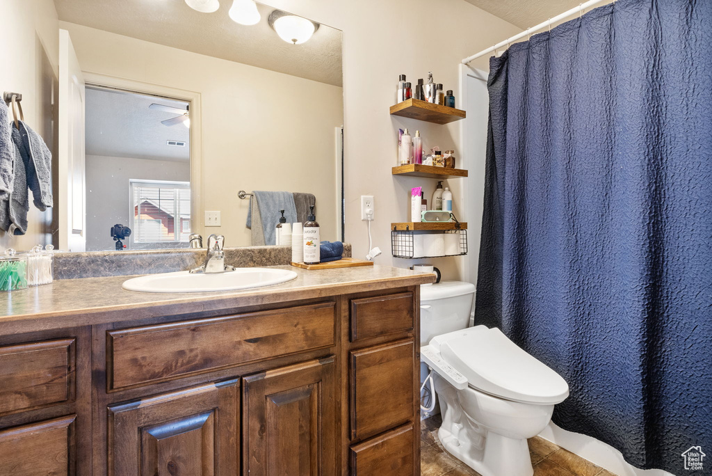 Full bathroom with vanity, tile patterned flooring, and curtained shower
