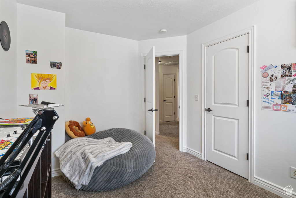 Bedroom featuring carpet floors and baseboards