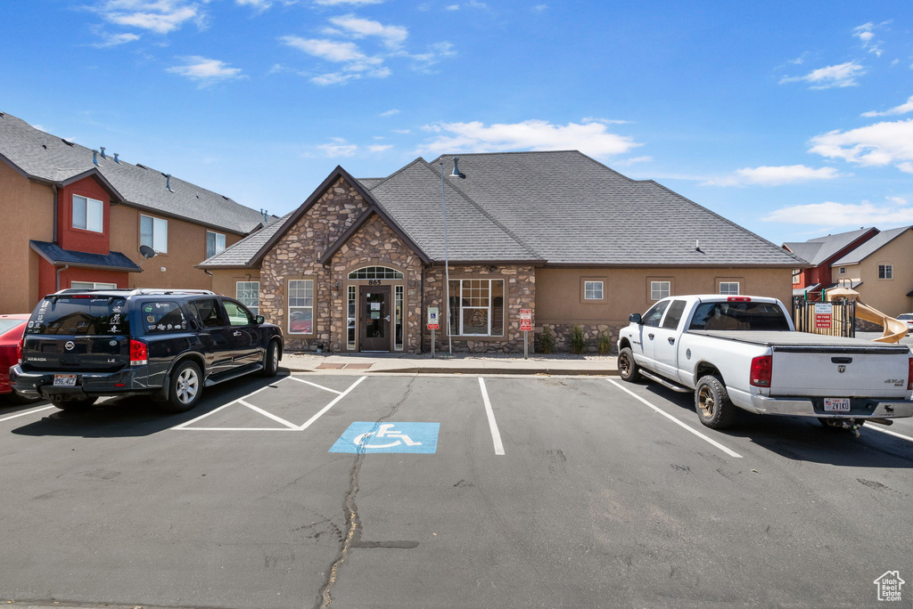 View of property with uncovered parking
