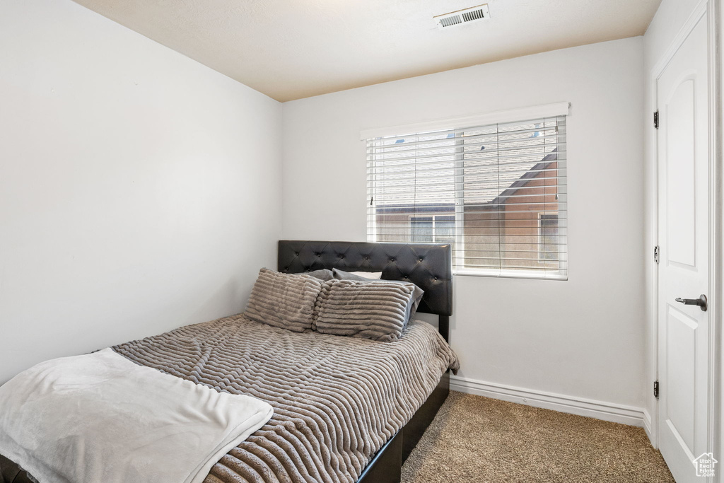 Bedroom featuring carpet flooring and baseboards