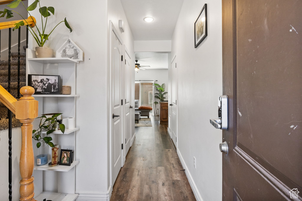 Corridor with wood finished floors and stairway