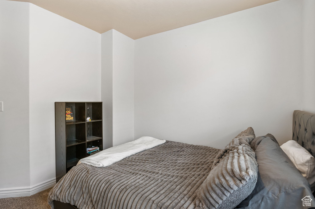 Bedroom with carpet flooring and baseboards