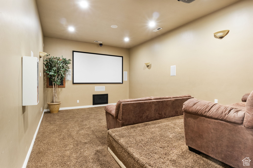 Carpeted home theater with recessed lighting and baseboards