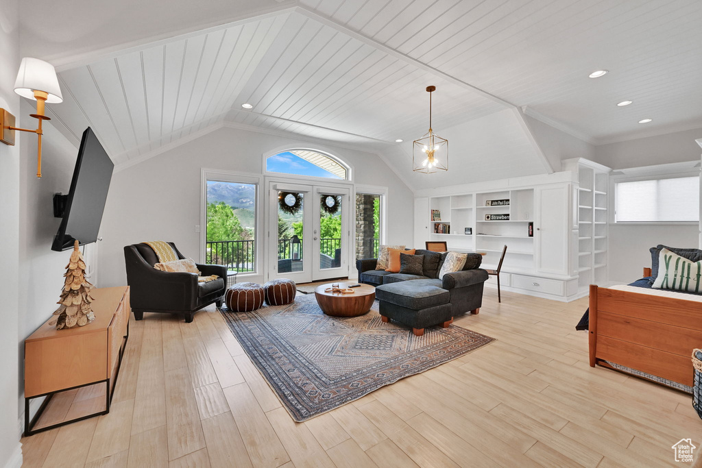 Living room with light wood-style flooring, lofted ceiling, wooden ceiling, recessed lighting, and built in shelves