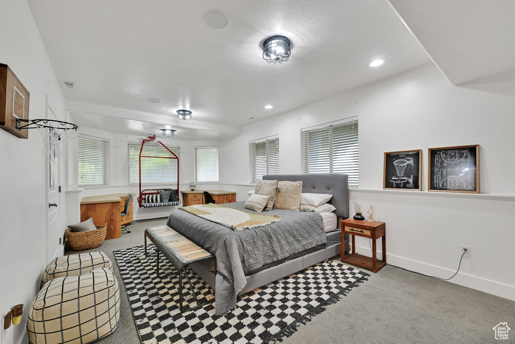 Carpeted bedroom featuring multiple windows and recessed lighting
