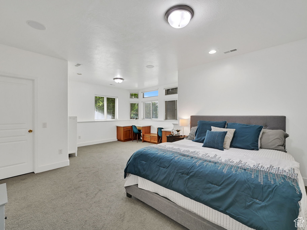 Carpeted bedroom featuring baseboards