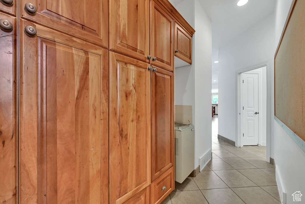 Mudroom with light tile patterned floors and baseboards
