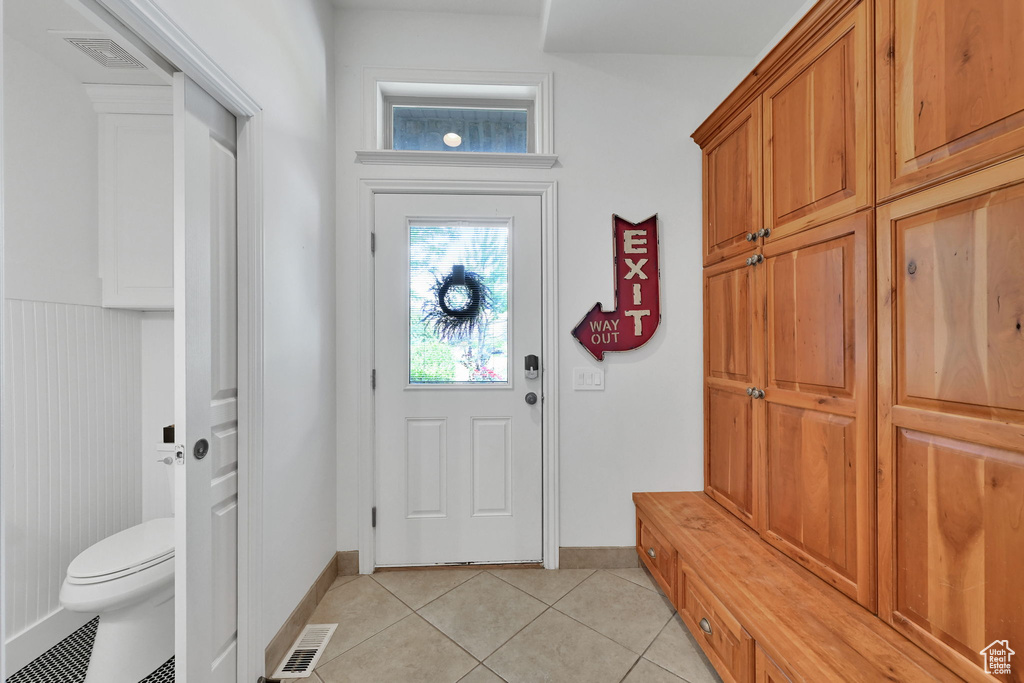 Mudroom with light tile patterned floors and baseboards