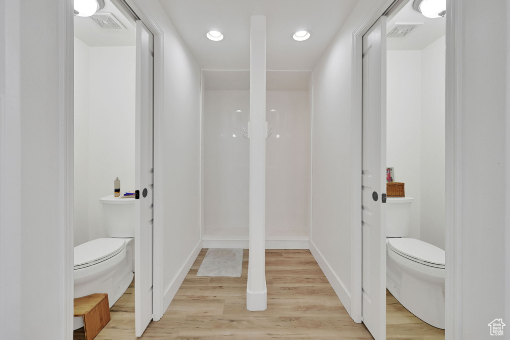 Bathroom featuring wood finished floors and recessed lighting