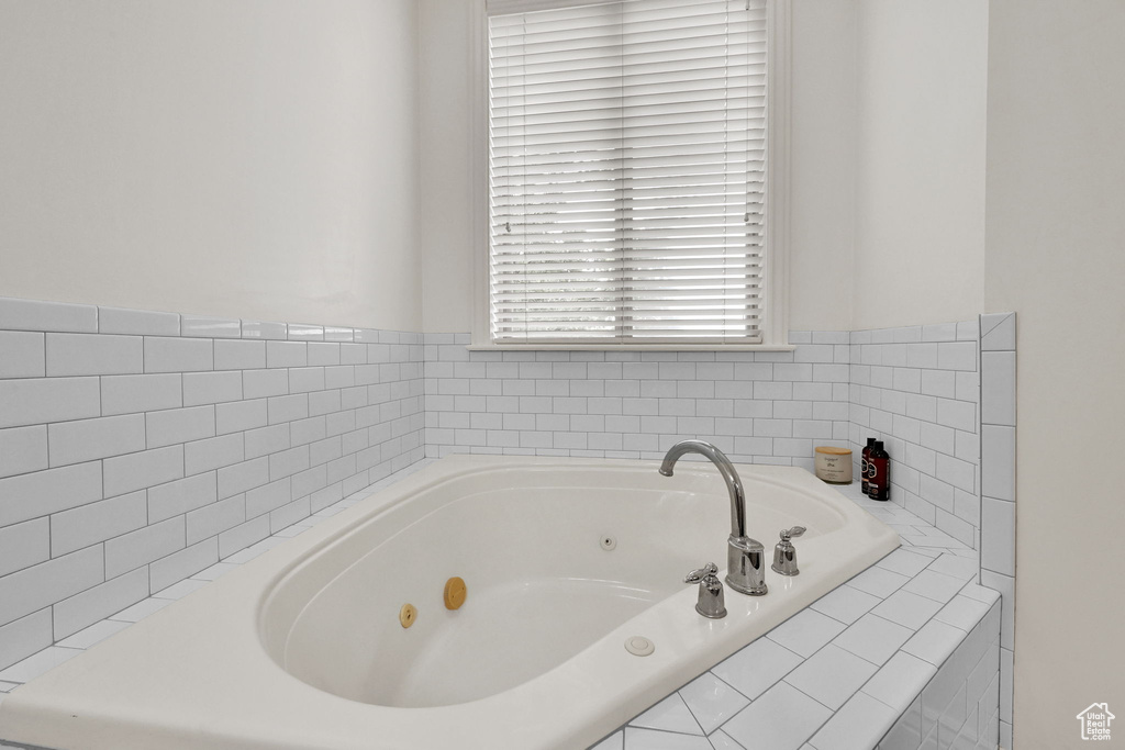 Full bathroom with a whirlpool tub
